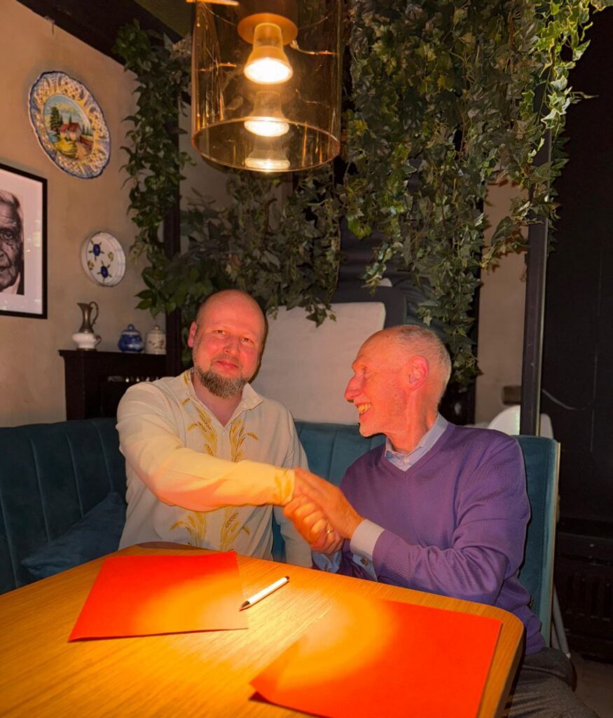 Голова АСУ тисне руку новому партнеру після підписання меморандуму на GICHD Innovation Conference 2025