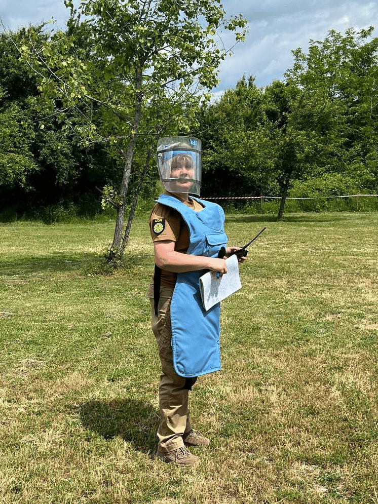 Tetiana surveying potentially mined areas
